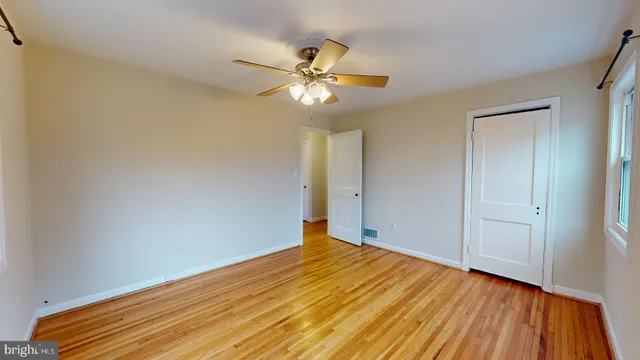 a view of empty room with wooden floor