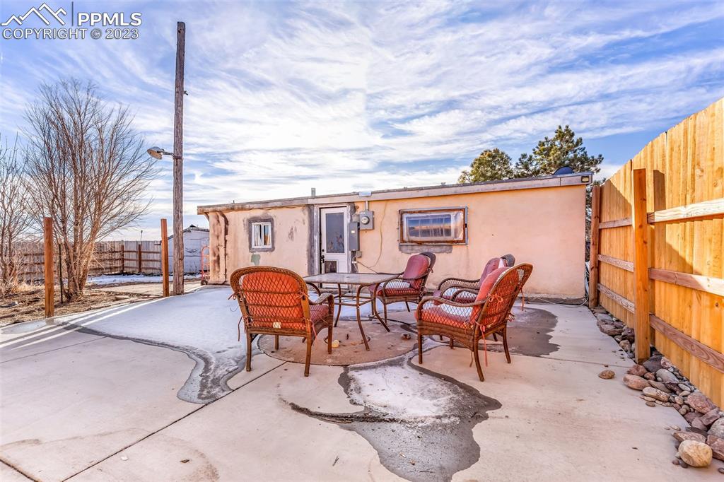 1417 2nd Road Pueblo, CO 81007 - Photo 17 of 32 a backyard of a house with table and chairs