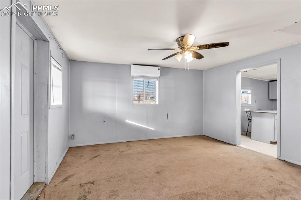 1417 2nd Road Pueblo, CO 81007 - Photo 3 of 32 wooden floor in an empty room with a window