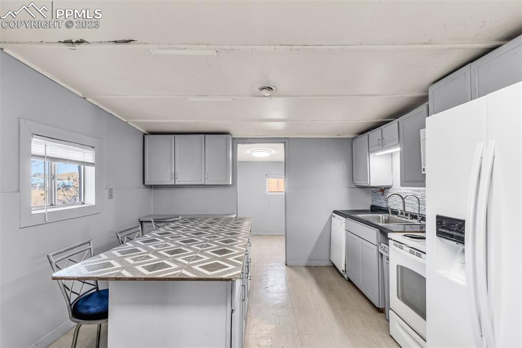 1417 2nd Road Pueblo, CO 81007 - Photo 7 of 32 a kitchen with stainless steel appliances granite countertop a sink stove and refrigerator