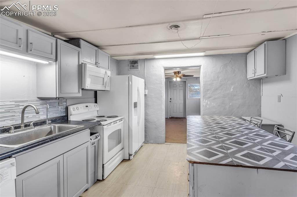 1417 2nd Road Pueblo, CO 81007 - Photo 10 of 32 a kitchen with a sink stove and refrigerator