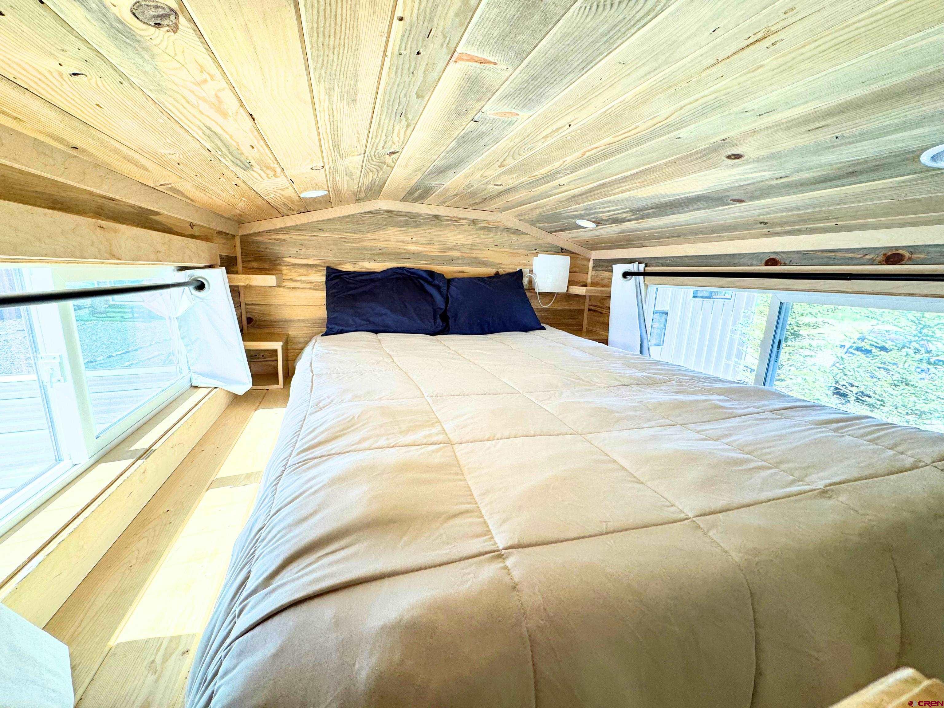 22130 6850 Road, Unit 212 Montrose, CO 81403 - Photo 15 of 29 a bedroom with a bed and a large window