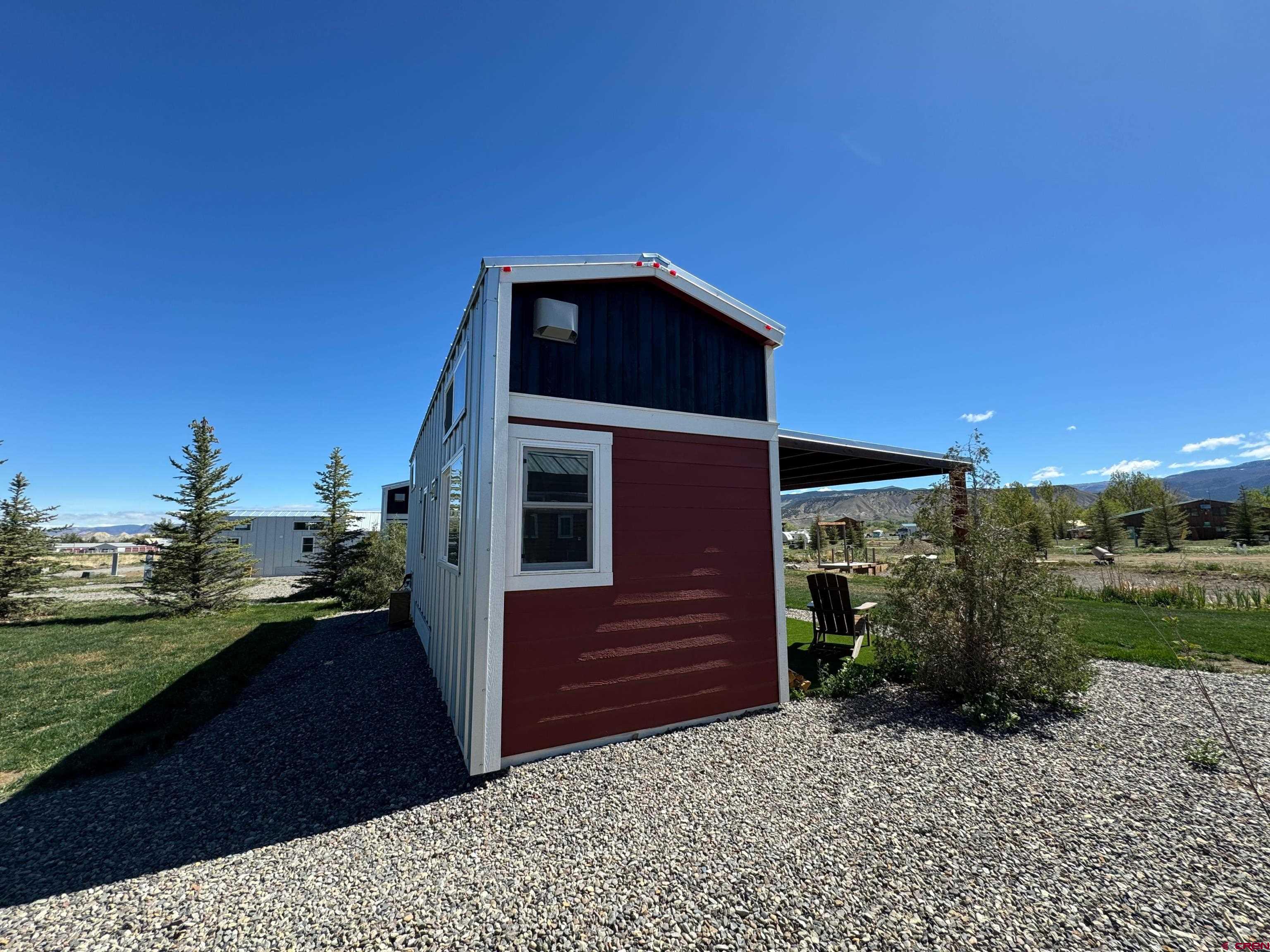 22130 6850 Road, Unit 212 Montrose, CO 81403 - Photo 17 of 29 a front view of a house with a yard