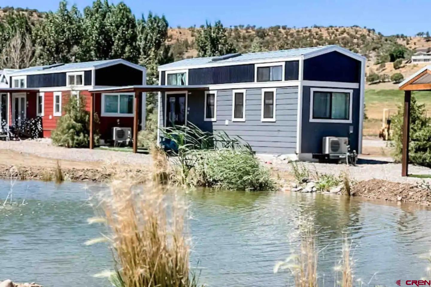 22130 6850 Road, Unit 212 Montrose, CO 81403 - Photo 20 of 29 a front view of a house with a yard