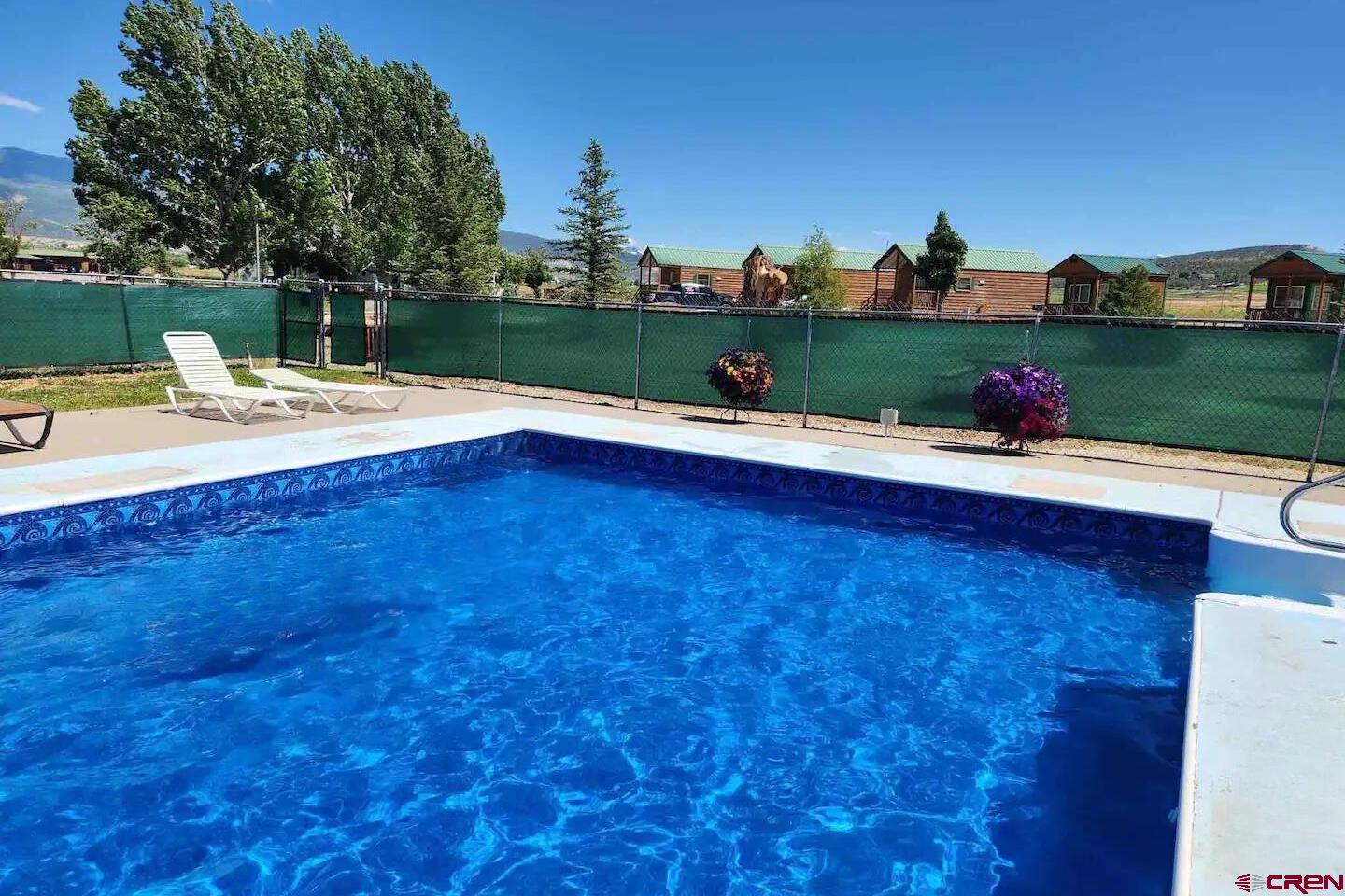 22130 6850 Road, Unit 212 Montrose, CO 81403 - Photo 21 of 29 a front view of a house with a yard