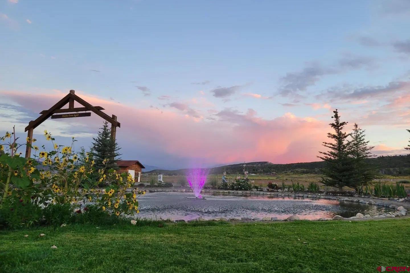 22130 6850 Road, Unit 212 Montrose, CO 81403 - Photo 22 of 29 a front view of a house with a yard