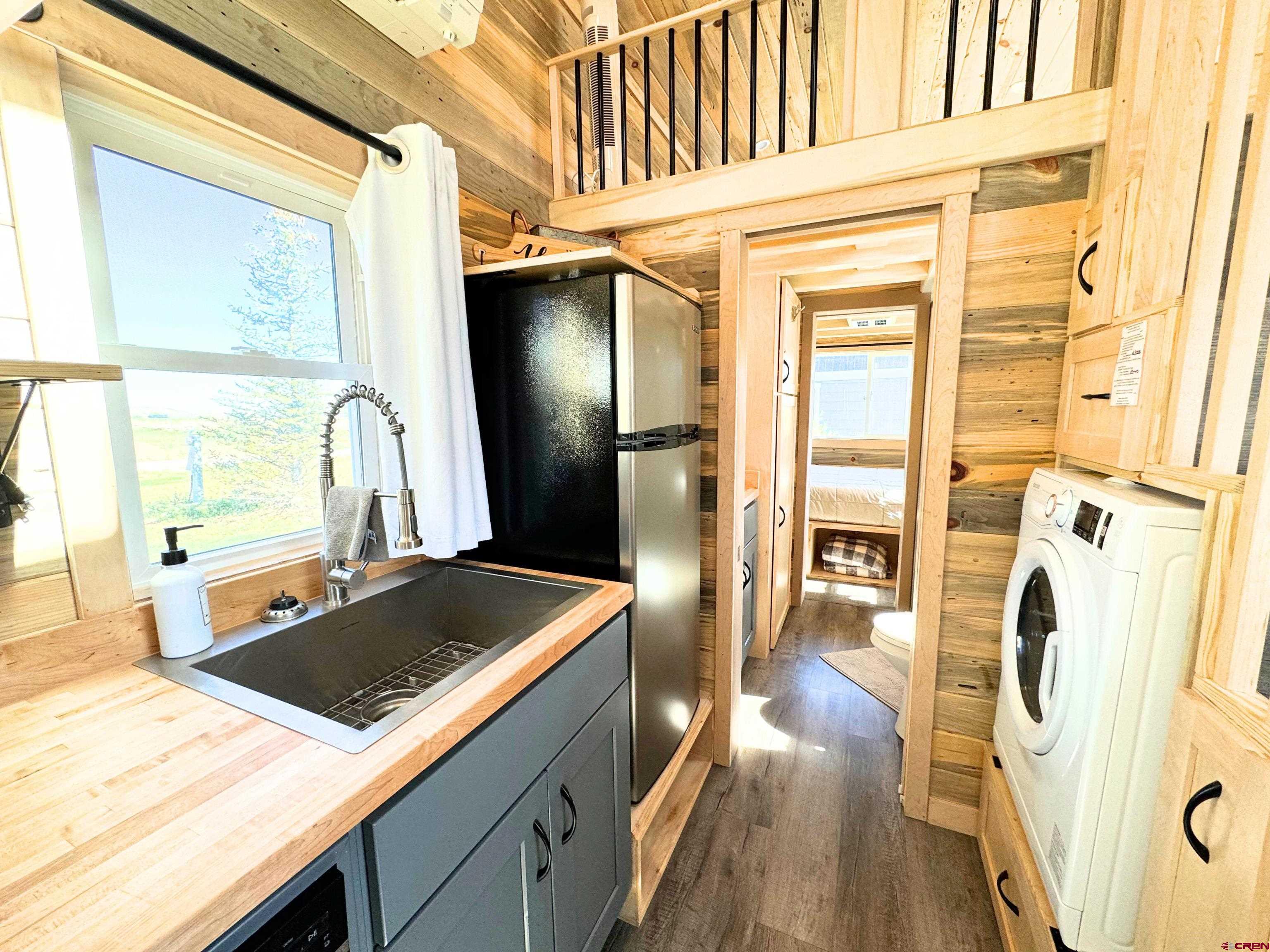 22130 6850 Road, Unit 212 Montrose, CO 81403 - Photo 6 of 29 a kitchen with a sink appliances and cabinets