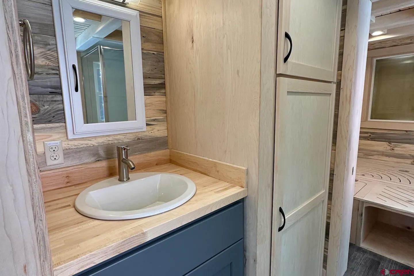 22130 6850 Road, Unit 212 Montrose, CO 81403 - Photo 9 of 29 a bathroom with a sink and a mirror