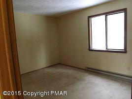 167 Magic Mountain Road Henryville, PA 18332 - Photo 4 of 7 an empty room with a window