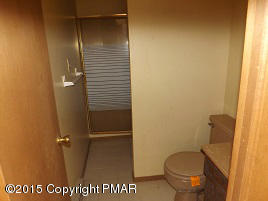167 Magic Mountain Road Henryville, PA 18332 - Photo 7 of 7 a bathroom with a granite countertop toilet and a sink