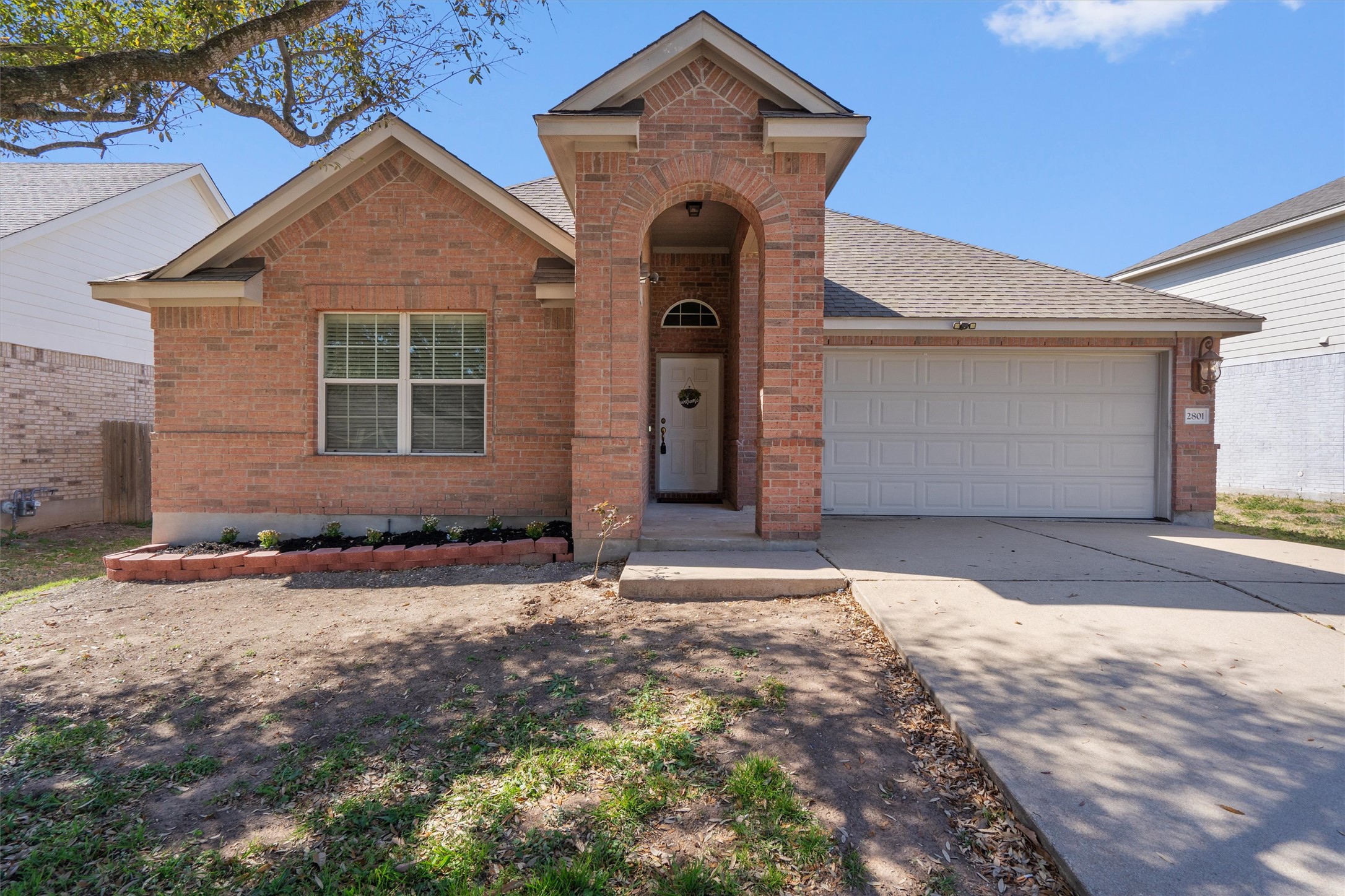 2801 Kickapoo Cavern Drive Pflugerville, TX 78660 - Photo 2 of 38 View of front of home with a garage, driveway, brick siding, and a shingled roof
