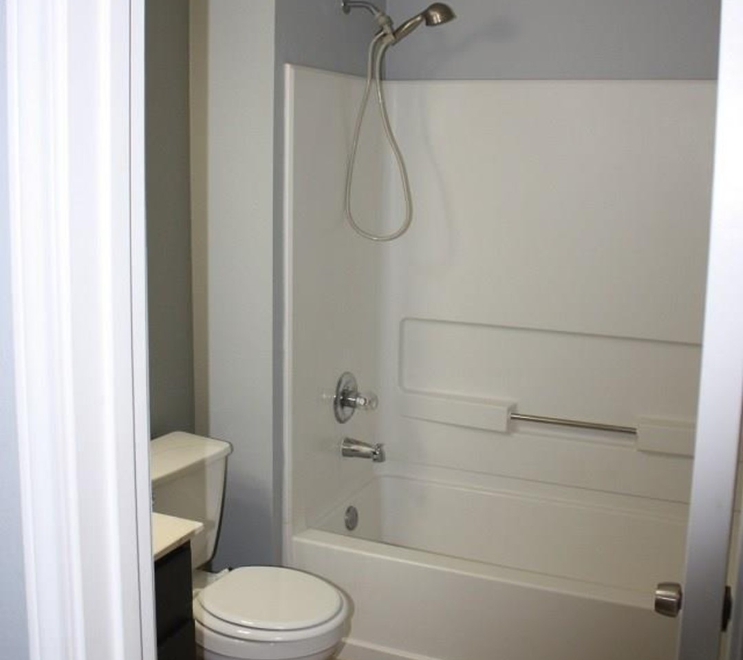 1120 Apollo Circle Round Rock, TX 78664 - Photo 4 of 14 White fiberglass tub and shower combination with a handheld showerhead