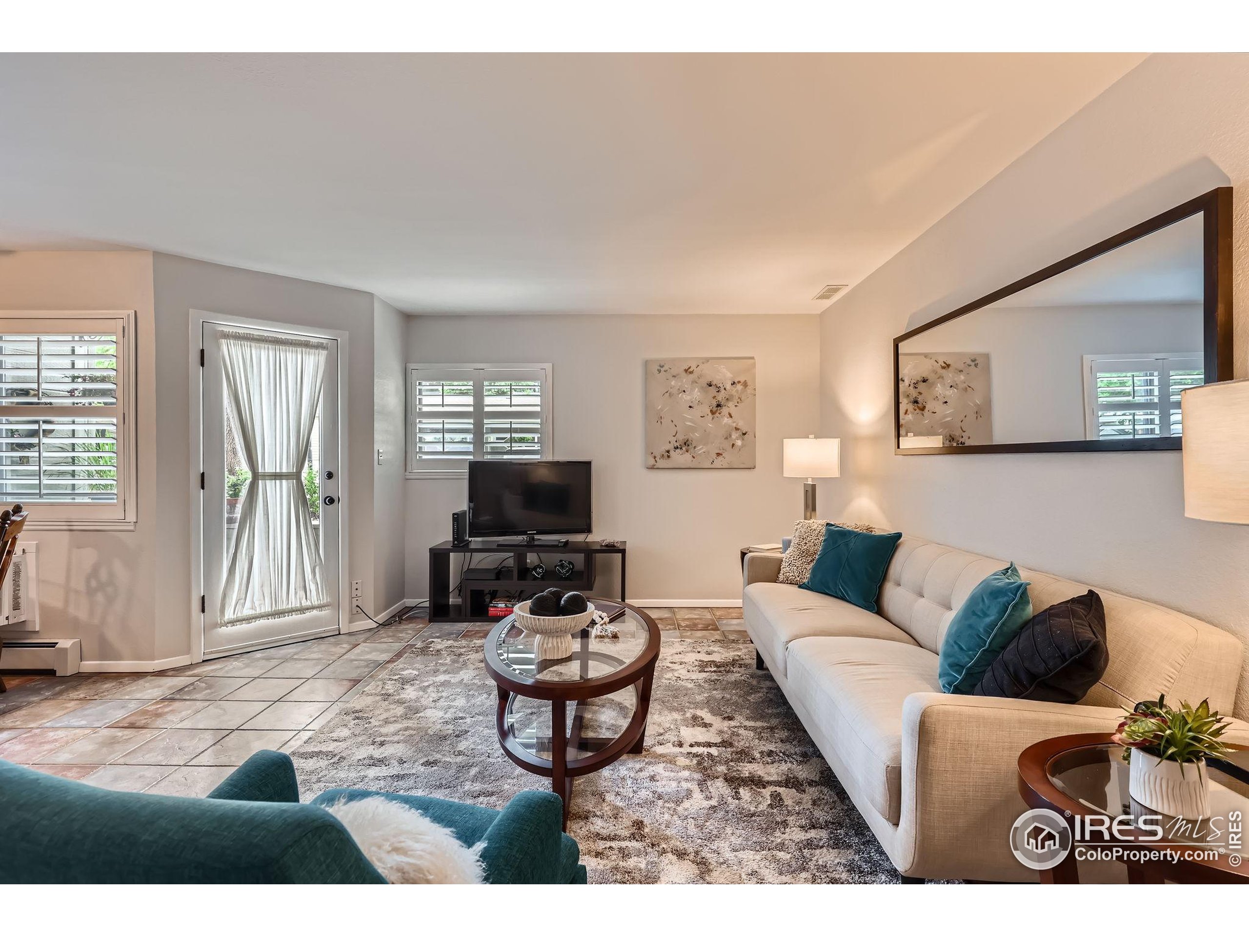3515 28th Street, Unit 108 Boulder, CO 80301 - Photo 1 of 29 a living room with furniture and a flat screen tv