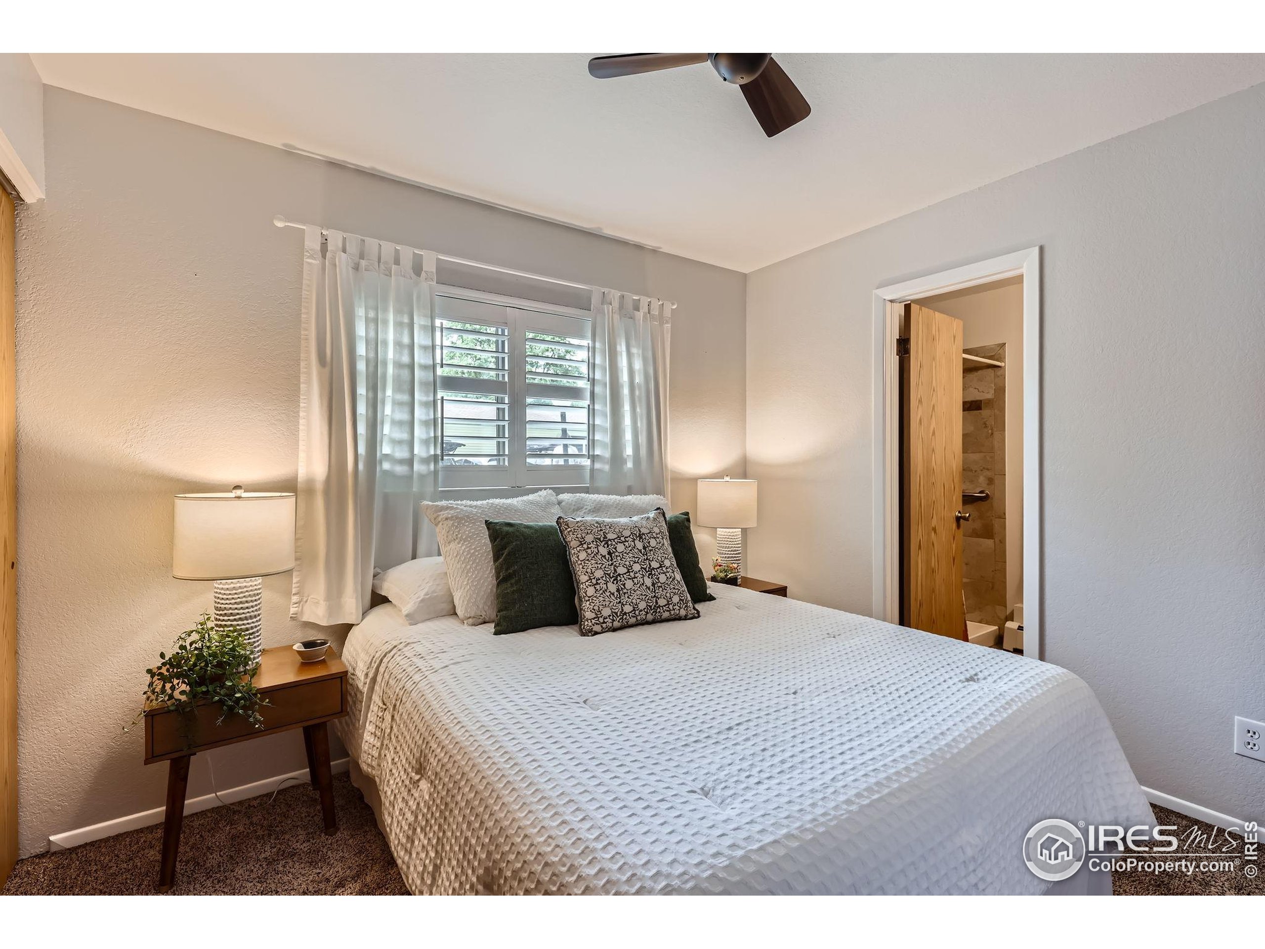 3515 28th Street, Unit 108 Boulder, CO 80301 - Photo 11 of 29 a bedroom with a large bed and a large window