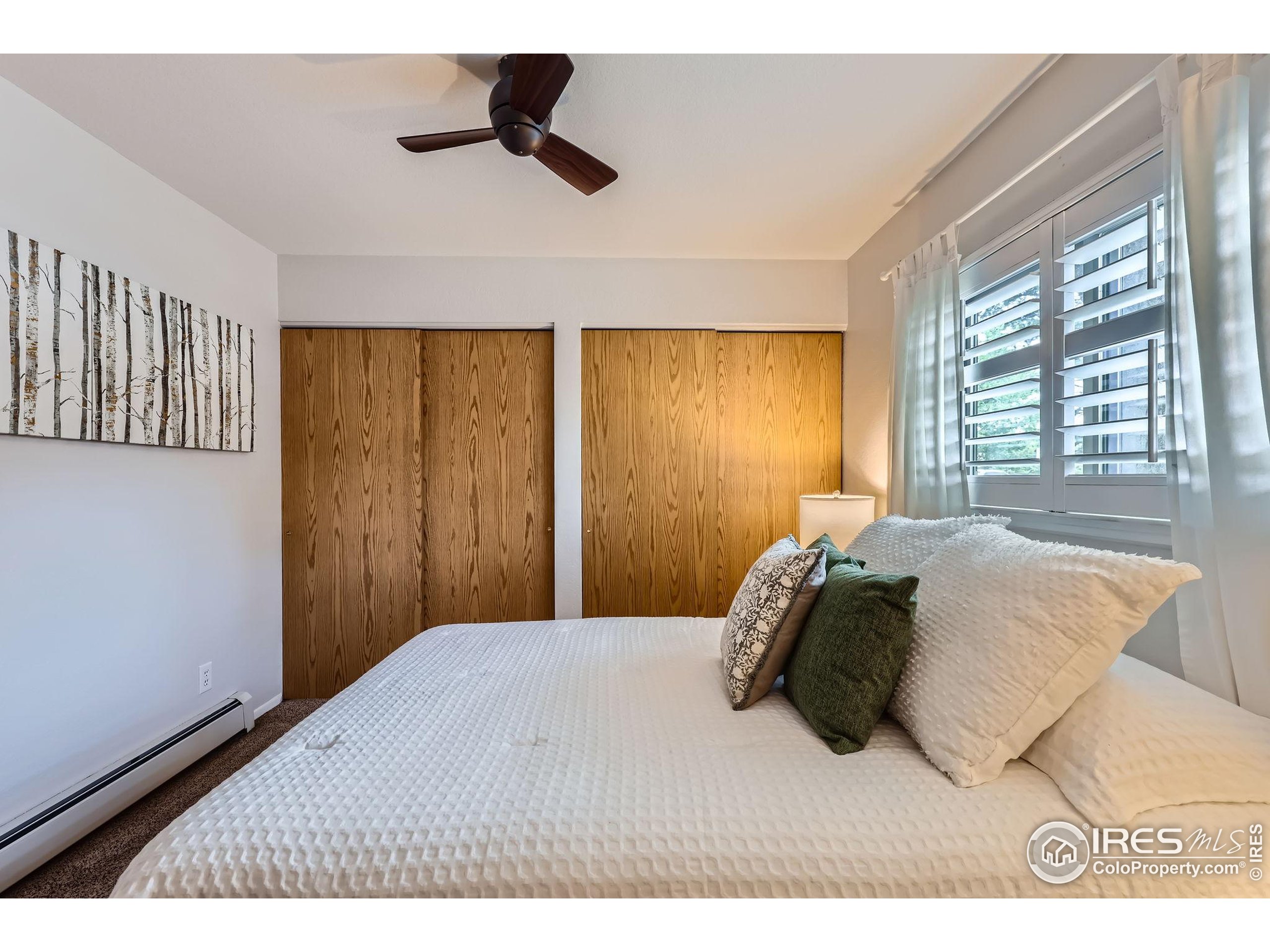 3515 28th Street, Unit 108 Boulder, CO 80301 - Photo 12 of 29 a bedroom with a bed and a painting on the wall
