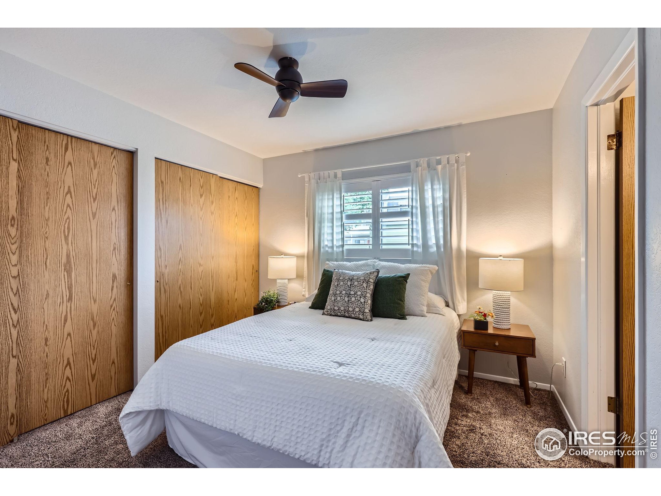 3515 28th Street, Unit 108 Boulder, CO 80301 - Photo 13 of 29 a bedroom with a bed and a lamp