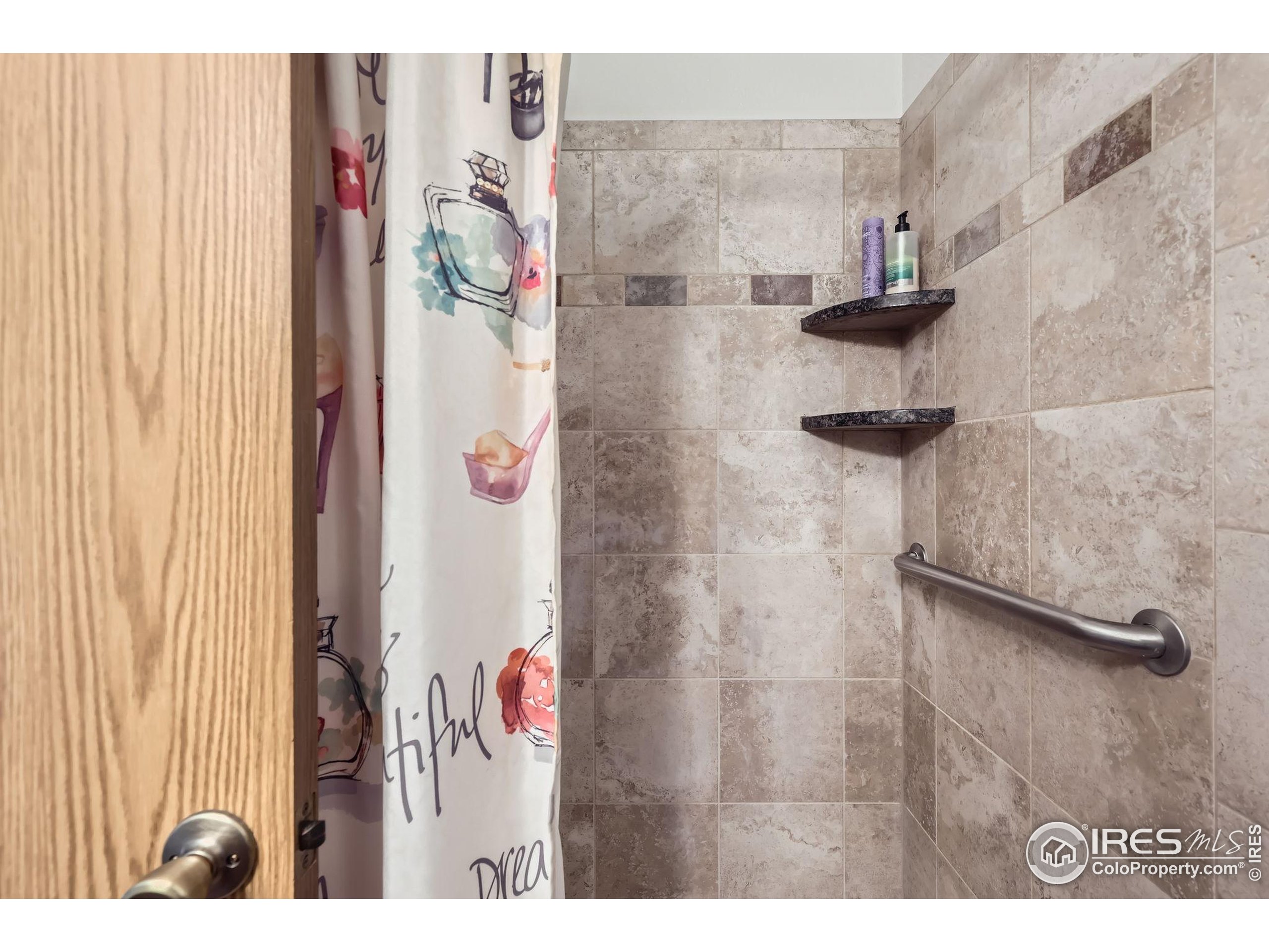 3515 28th Street, Unit 108 Boulder, CO 80301 - Photo 15 of 29 a bathroom with a shower and a shower curtain