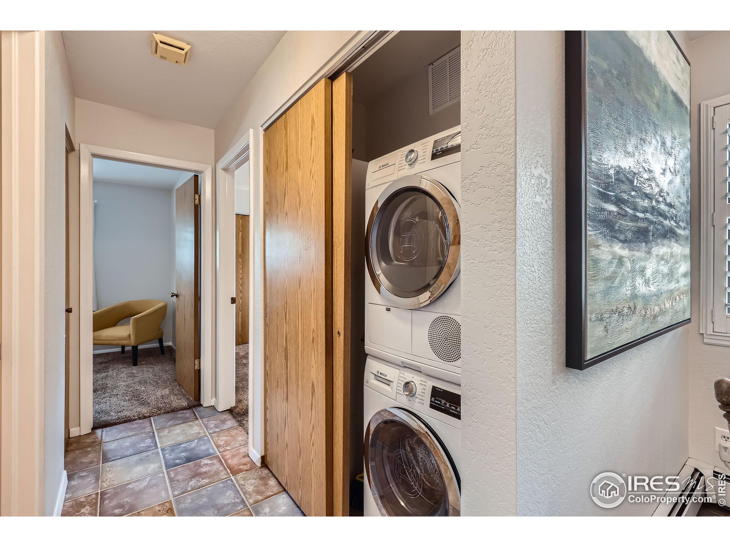 3515 28th Street, Unit 108 Boulder, CO 80301 - Photo 20 of 29 a view of a bedroom with washer and dryer