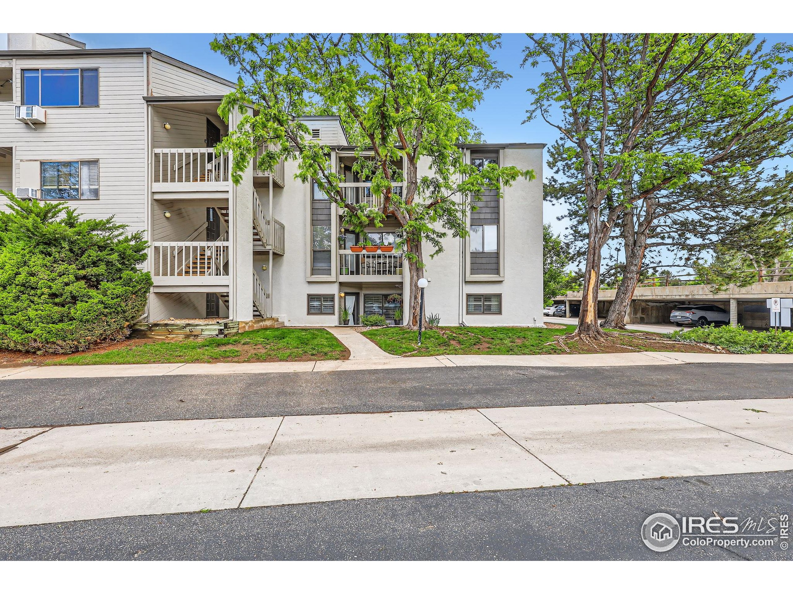 3515 28th Street, Unit 108 Boulder, CO 80301 - Photo 2 of 29 a front view of a building with a garden and plants