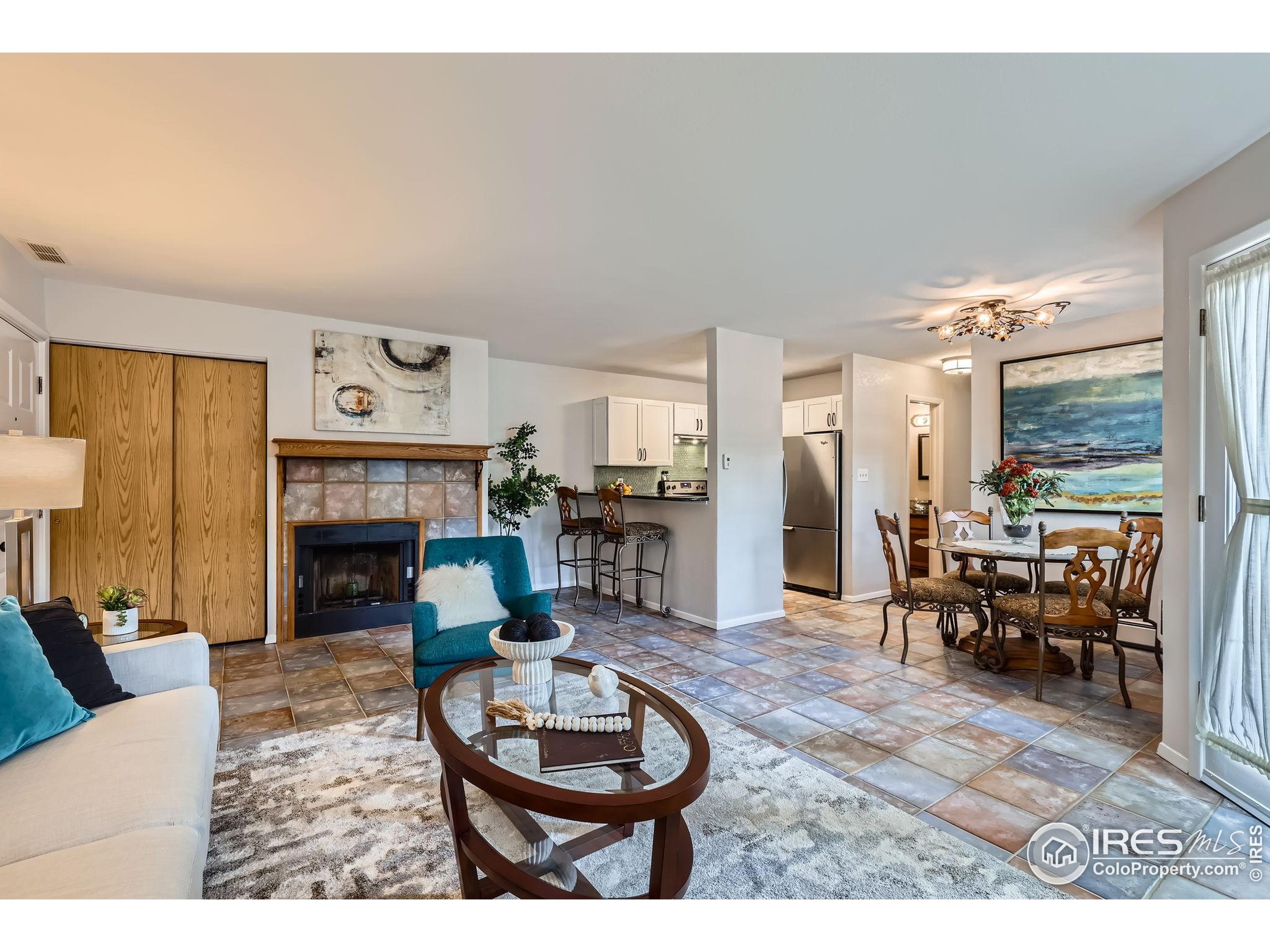 3515 28th Street, Unit 108 Boulder, CO 80301 - Photo 5 of 29 a living room with furniture and a fireplace