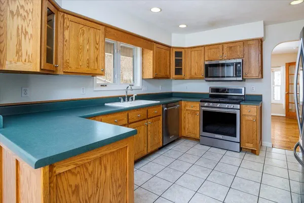 a bedroom with a bed dresser and a window