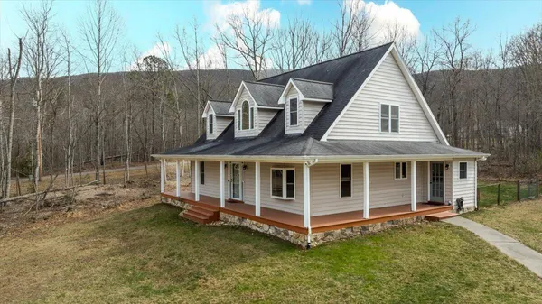 a view of a livingroom with a fireplace and window