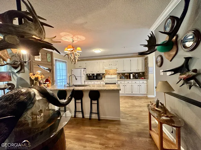 a kitchen with stainless steel appliances granite countertop a sink a stove and a refrigerator