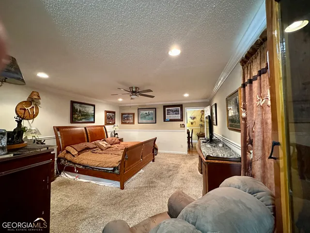 a living room with furniture kitchen view and a large window