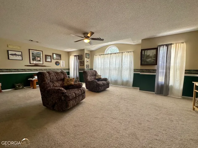 a living room with furniture window and a fireplace