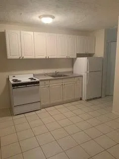 a kitchen with cabinets and white stainless steel appliances
