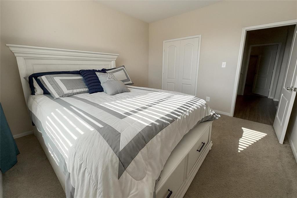 1837 Rialto Lane Crowley, TX 76036 - Photo 8 of 24 Carpeted bedroom with a built-in closet featuring bi-fold doors
