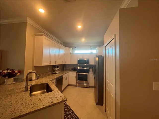a kitchen with a sink and a refrigerator