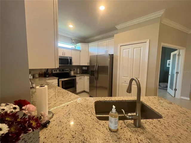 a kitchen with a refrigerator sink and stove