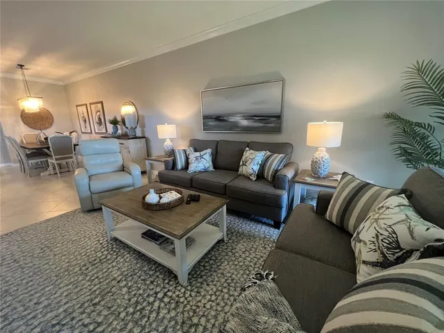 a living room with furniture a lamp and a rug