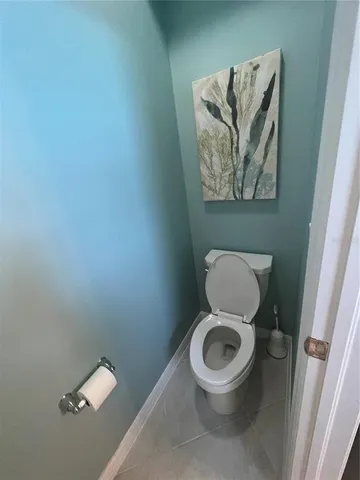 a white toilet sitting in a bathroom