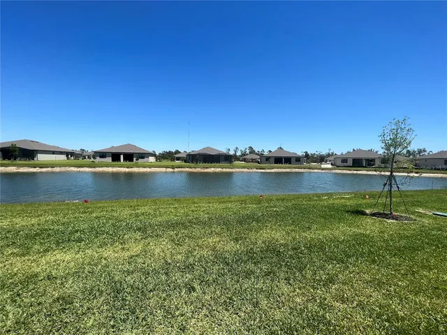 a view of a lake with houses in the back