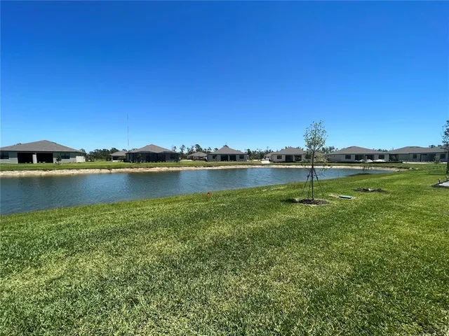 a view of a lake with houses in the back