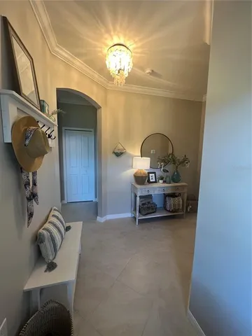 a living room with furniture and a chandelier