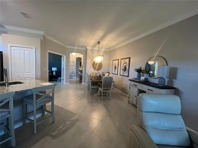 a living room with furniture a dining table and chairs