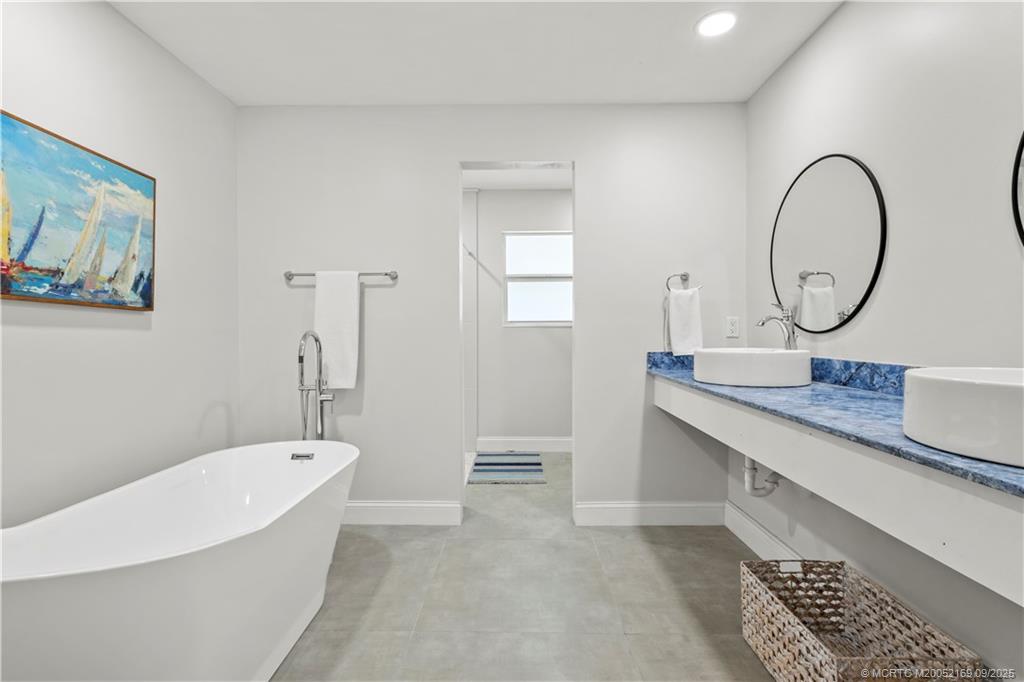 1001 South 11th Street Fort Pierce, FL 34950 - Photo 39 of 80 a bathroom with a tub sink and mirror