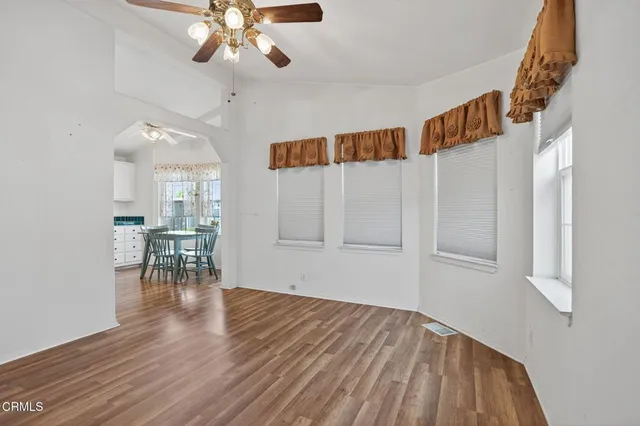 a view of an empty room and wooden floor