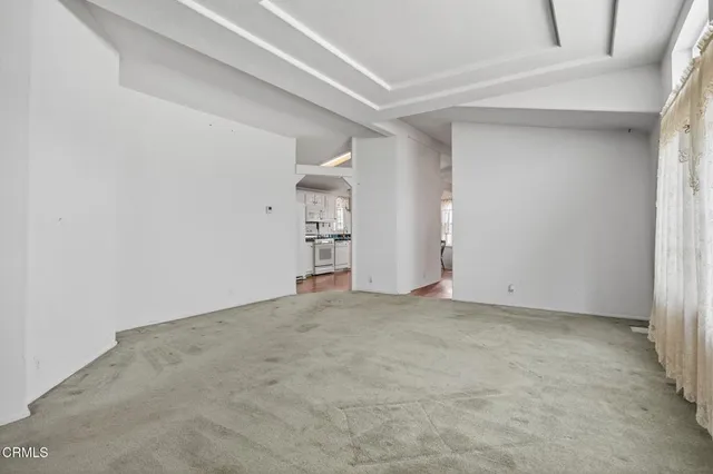 an empty room with closet and natural light