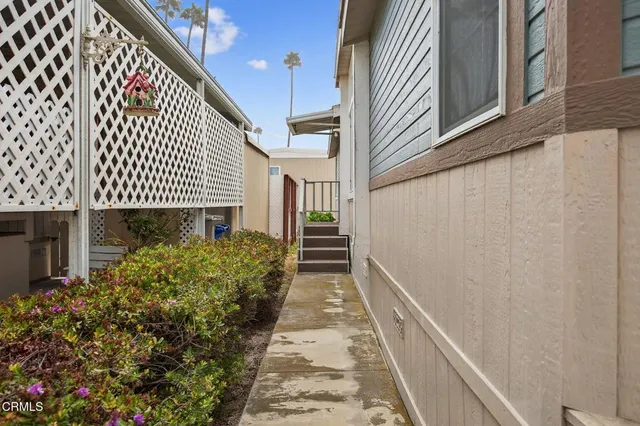 a view of a pathway of a house with a garage