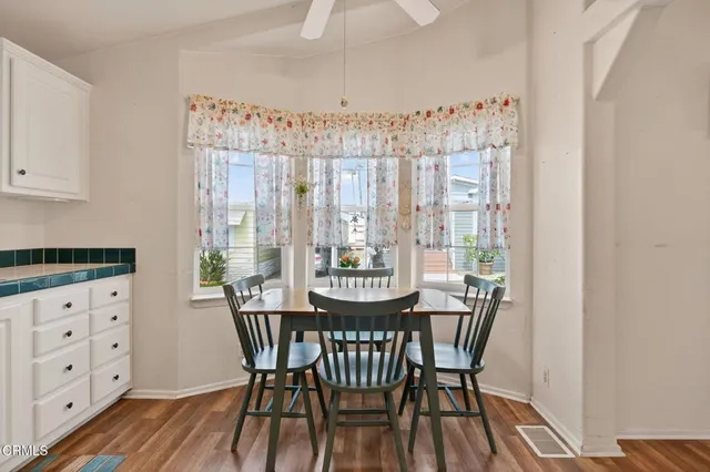 a view of a dining room with furniture window and wooden floor