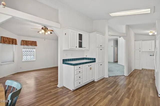 a kitchen with granite countertop a sink and a stove top oven