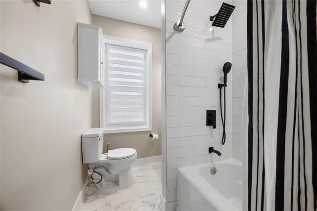 a bathroom with a bathtub and a toilet