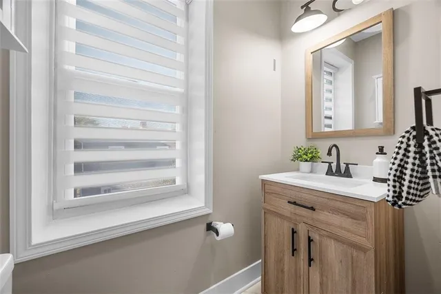 a bathroom with a sink vanity and a mirror