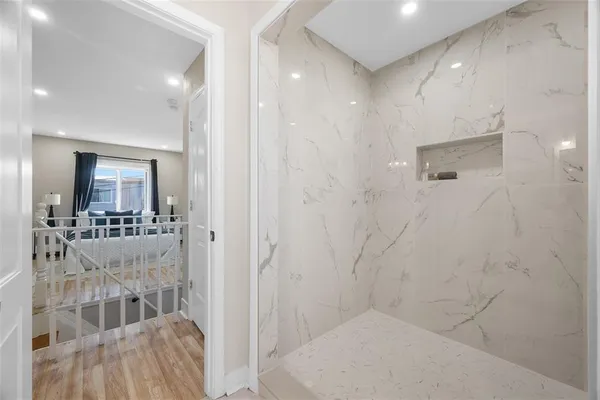 a bathroom with a glass door shower