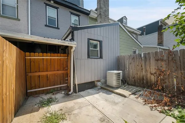 a backyard of a house with barbeque oven and outdoor seating
