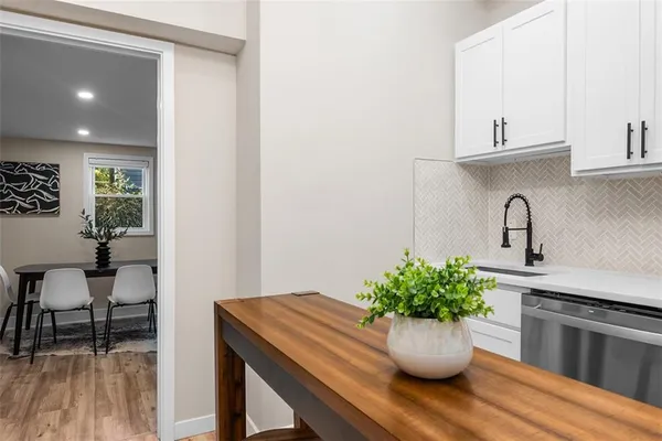 a kitchen with a table and potted plant